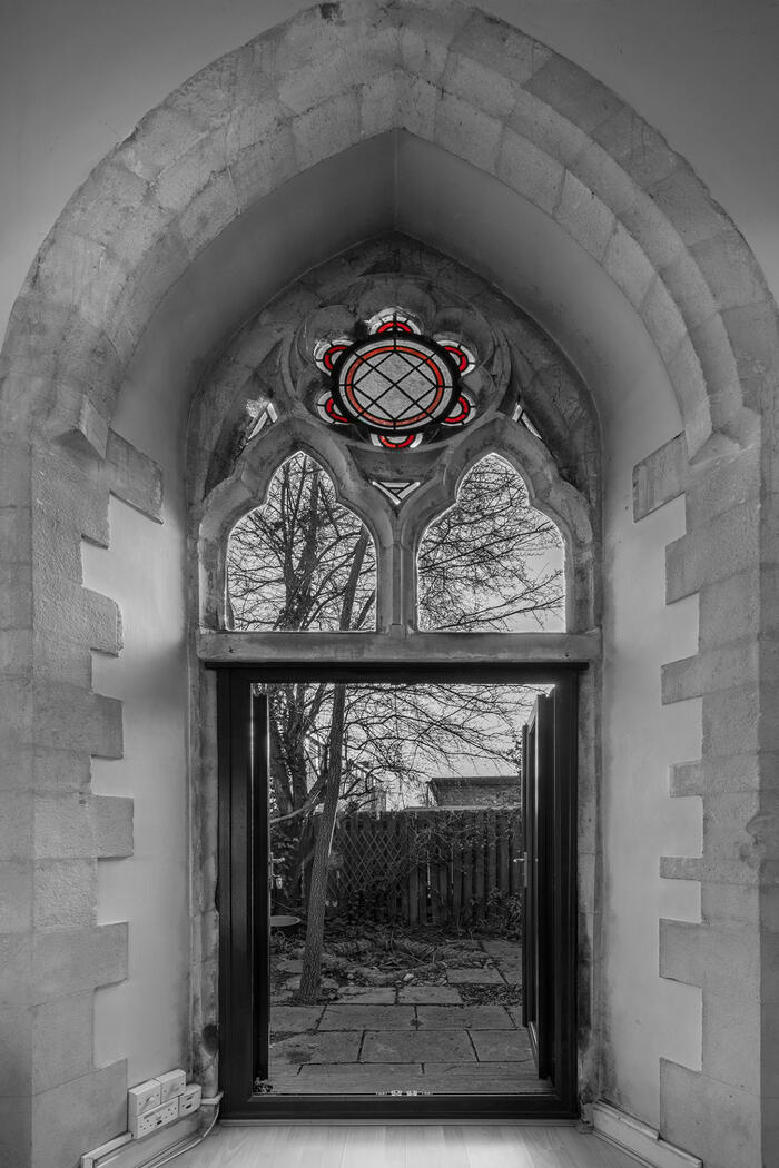 Gothic window arch with stain glass window